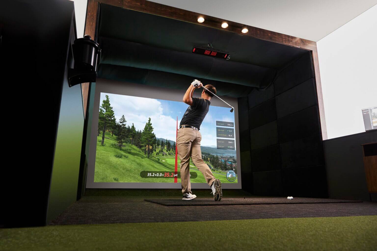 Golfer practicing at an indoor golf simulator